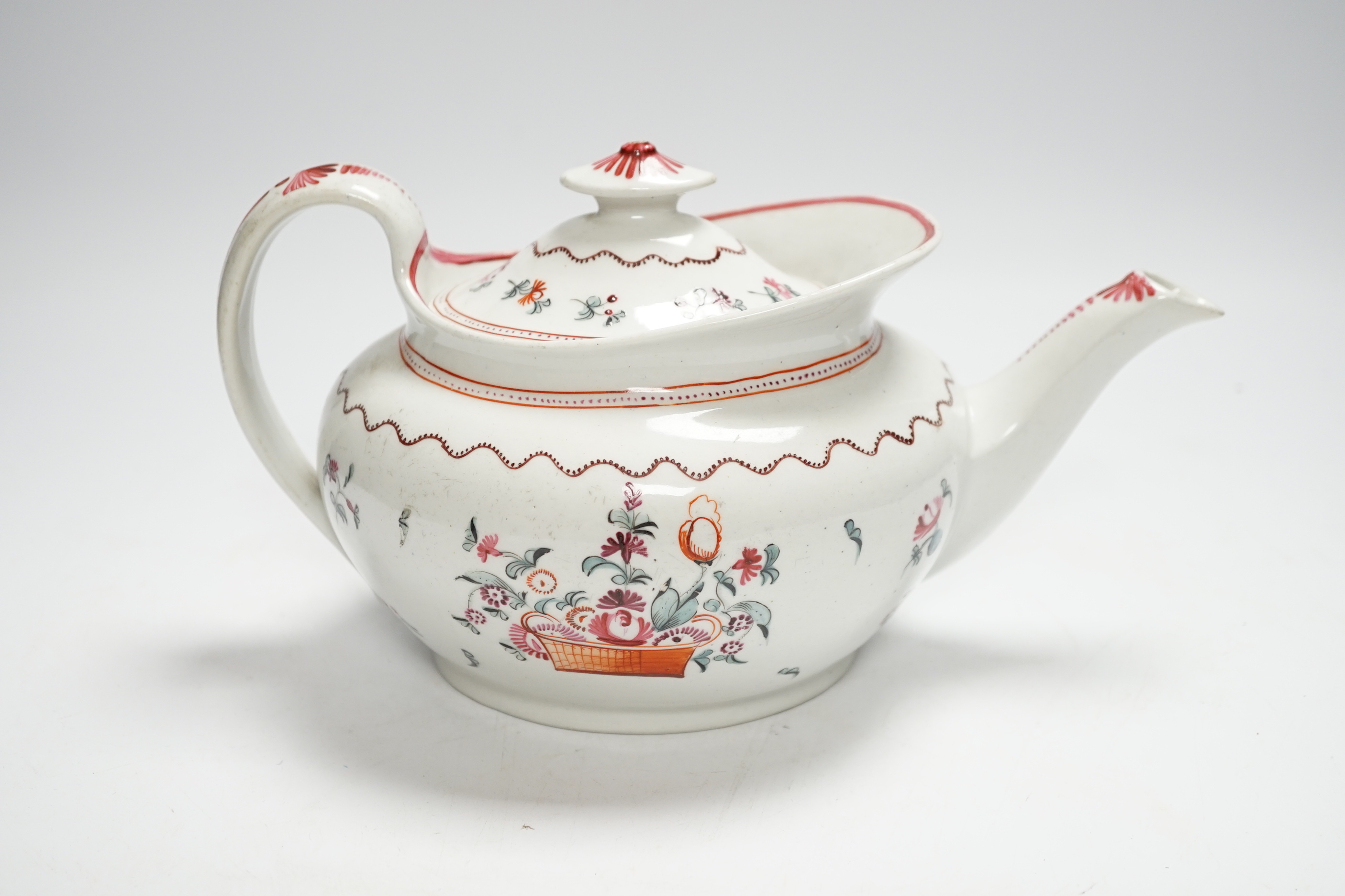 A Newhall porcelain boat shaped teapot, c.1800 with floral decoration, 25cm wide